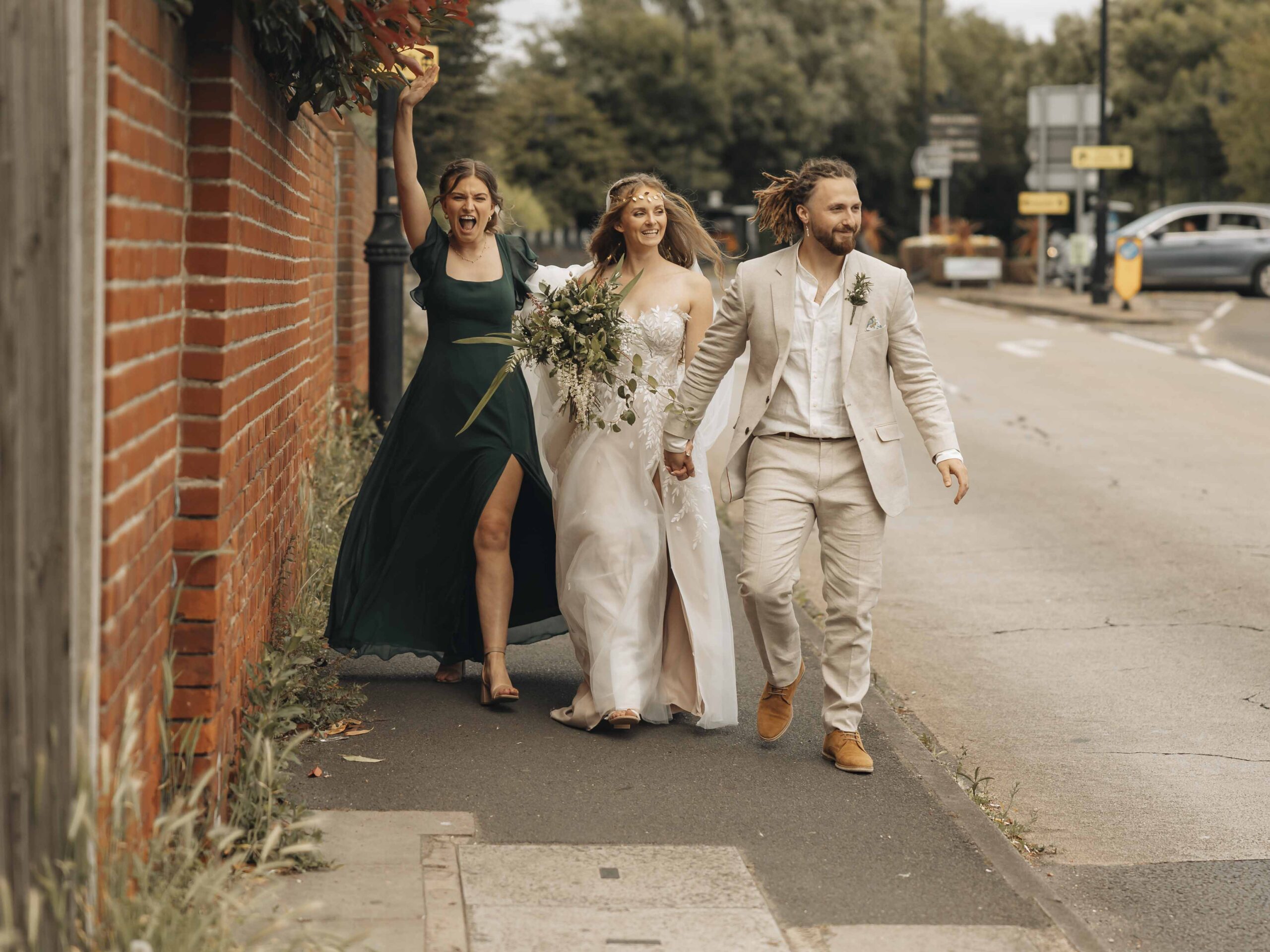 bridemaid cheering with newlyweds