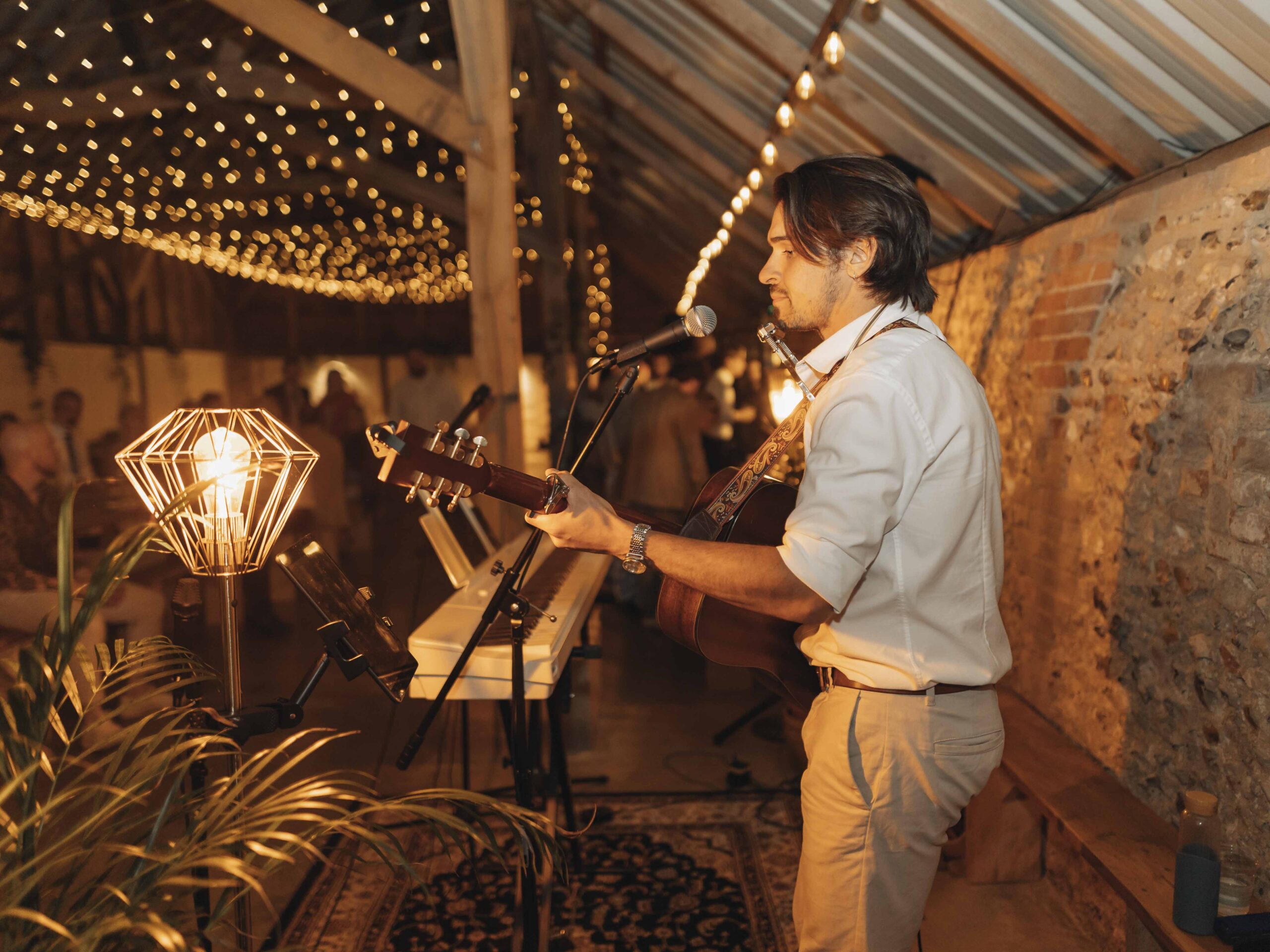 Man playing guitar at wedding