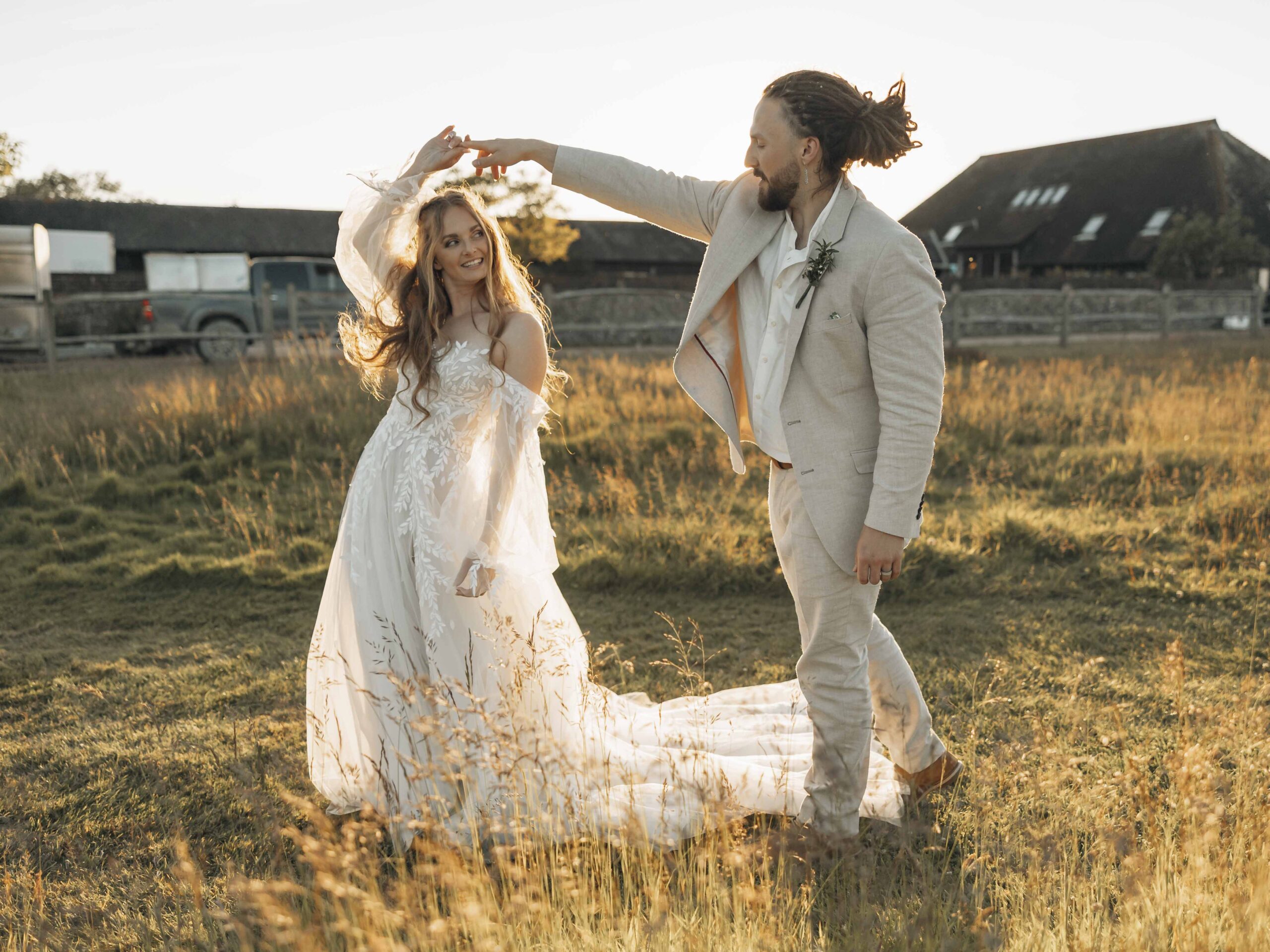 bride and groom dancing in the sunlight