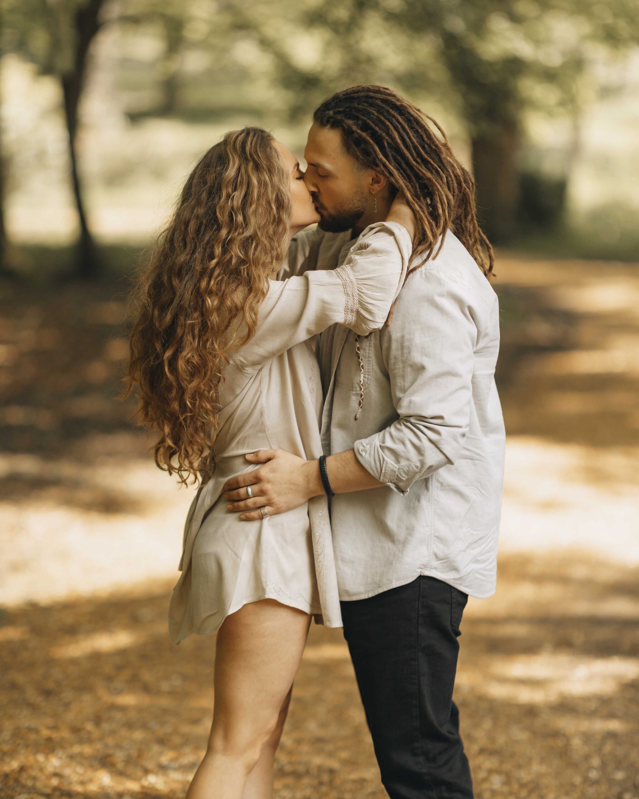 couple kissing in the woods